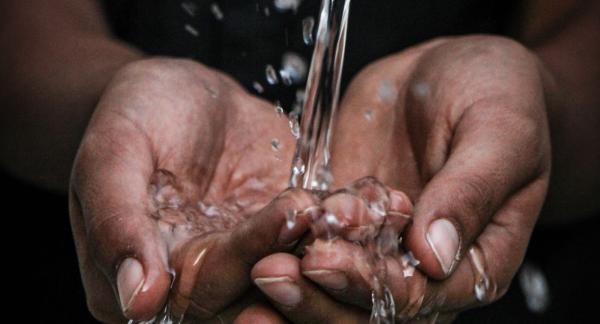 Close up of person washing their hands